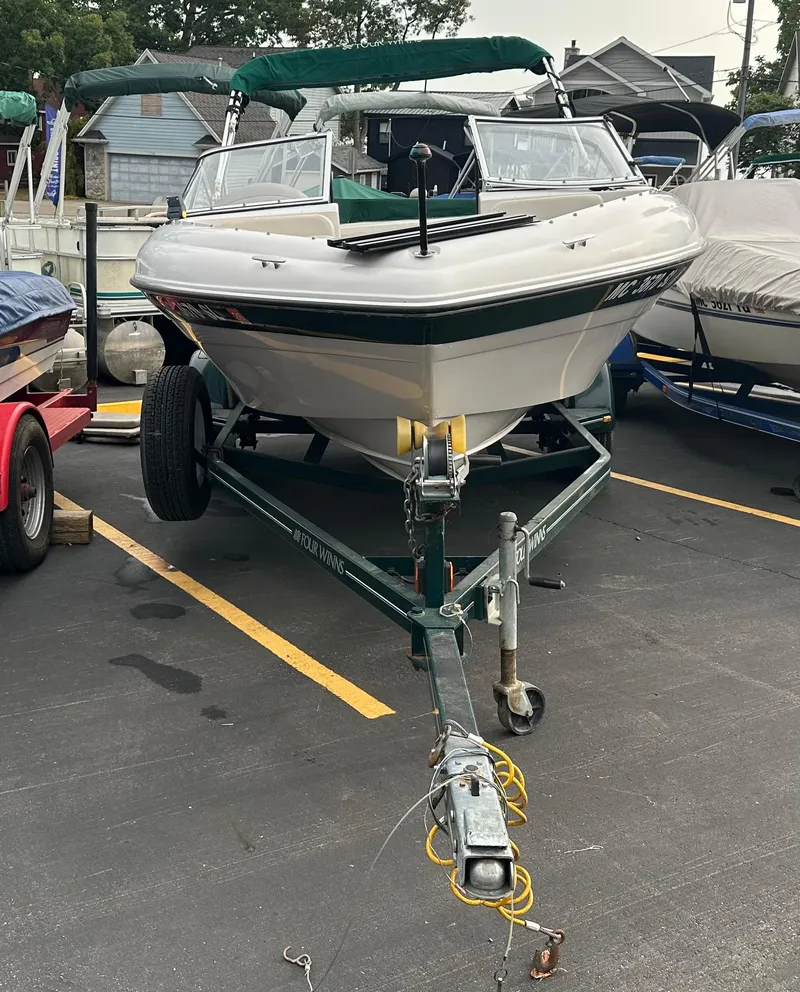 Slide: The Image of 2003 Four Winns Freedom 180F/S boat on trailer in parking lot. - 3