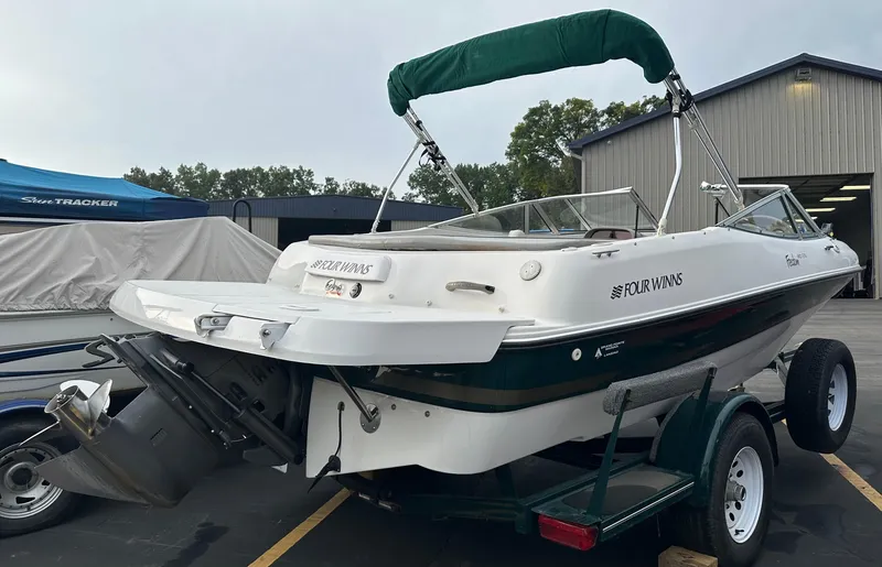 Slide: The Image of 2003 Four Winns Freedom 180F/S boat on trailer, parked outdoors. - 6