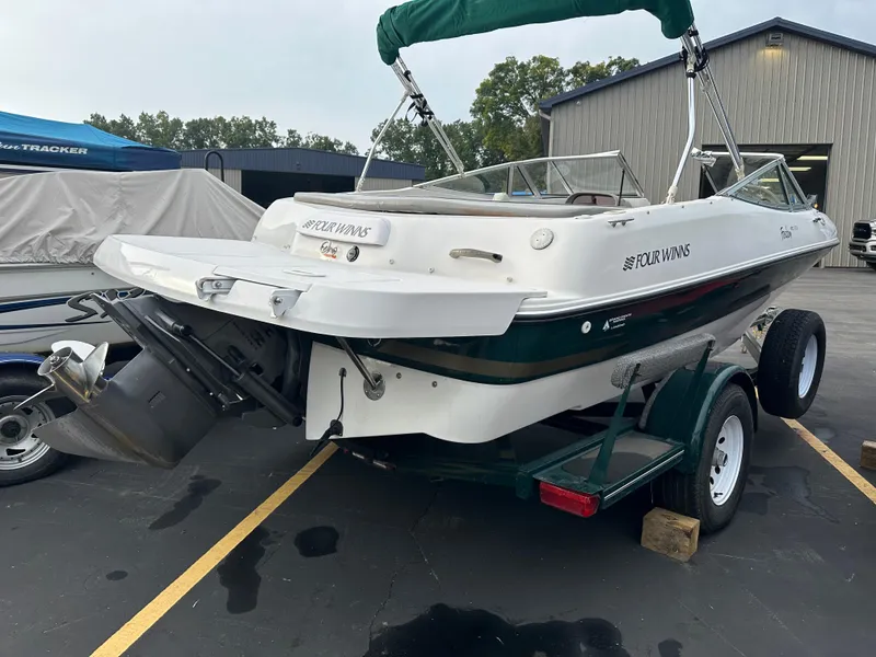 Slide: The Image of 2003 Four Winns Freedom 180F/S boat on trailer, parked outdoors. - 8