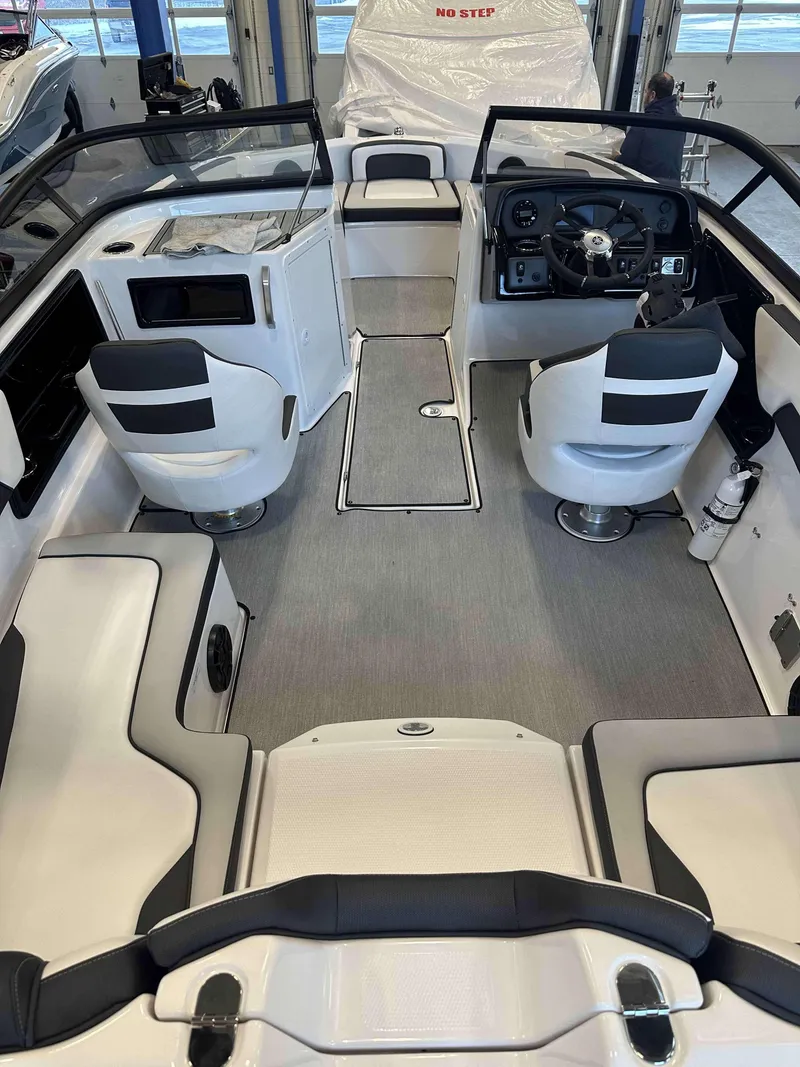 Slide: The Image of 2025 Yamaha Boats SX195 interior with modern seating and sleek dashboard design. - 4