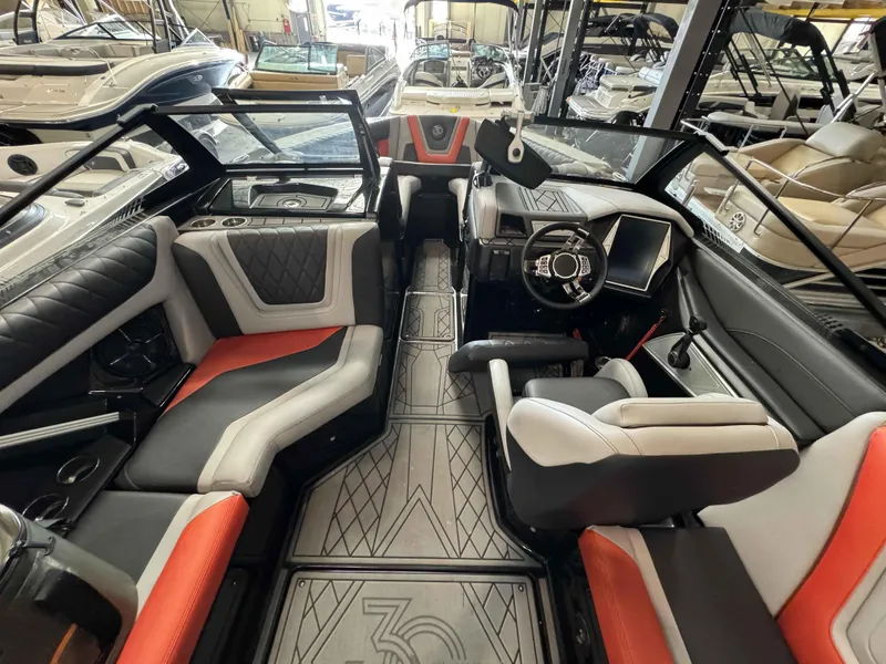 Slide: The Image of Interior of 2022 Tigé 23ZE boat with modern seating and dashboard in showroom. - 10