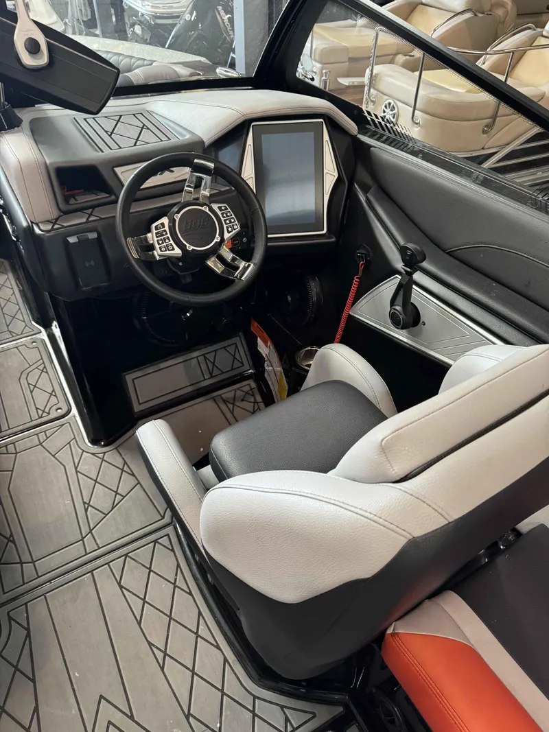 Slide: The Image of 2022 Tigé 23ZE boat interior with modern dashboard and steering wheel. - 13