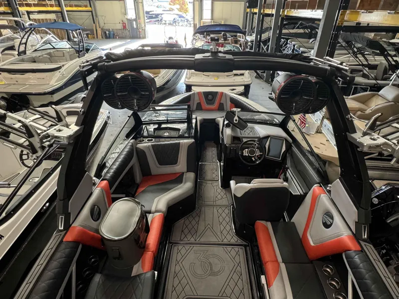 Slide: The Image of Interior of 2022 Tigé 23ZE boat with modern seating and audio system in a showroom. - 15