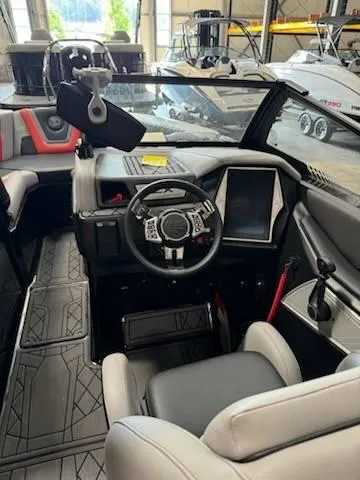 Slide: The Image of 2022 Tigé 23ZE boat interior with modern dashboard and steering wheel. - 21