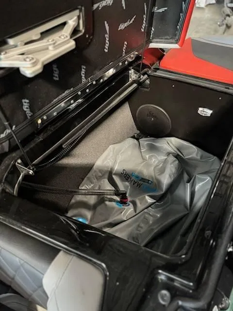 Slide: The Image of 2022 Tigé 23ZE boat storage compartment with ballast bag. - 23