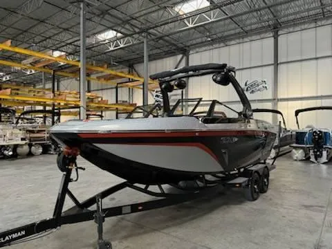 Slide: The Image of 2022 Tigé 23ZE boat in a warehouse, on a trailer, ready for transport. - 4