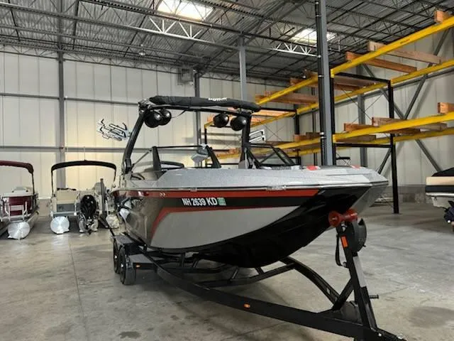 Slide: The Image of 2022 Tigé 23ZE boat in warehouse, sleek design, on trailer. - 5