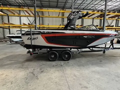 Slide: The Image of 2022 Tigé 23ZE boat in warehouse, black and white with red accents. - 6