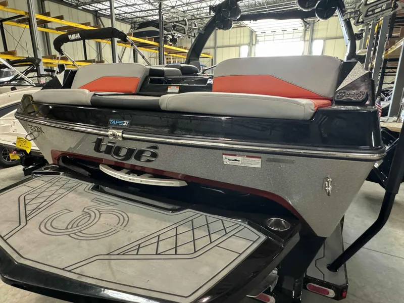 Slide: The Image of 2022 Tigé 23ZE boat in showroom, featuring sleek design and comfortable seating. - 7