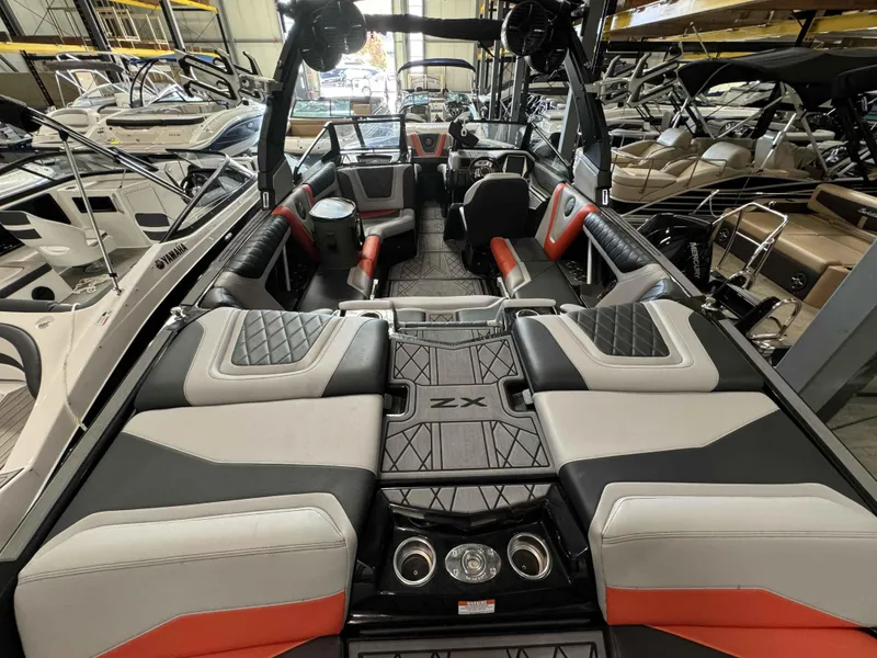 Slide: The Image of 2022 Tigé 23ZE boat interior with luxurious seating and modern design in a showroom. - 8