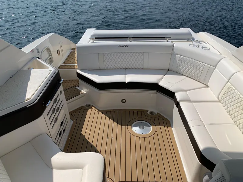 Slide: The Image of Luxurious 2019 Sea Ray SLX 310 boat interior with elegant seating and teak flooring. - 10