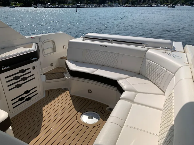 Slide: The Image of 2019 Sea Ray SLX 310 boat interior with luxurious seating and scenic water view. - 11