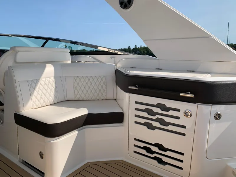 Slide: The Image of 2019 Sea Ray SLX 310 interior with white seating and sleek design. - 15