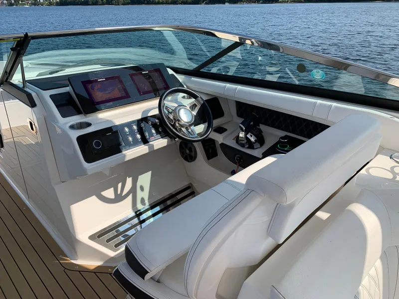 Slide: The Image of 2019 Sea Ray SLX 310 boat cockpit with modern controls and steering wheel. - 18
