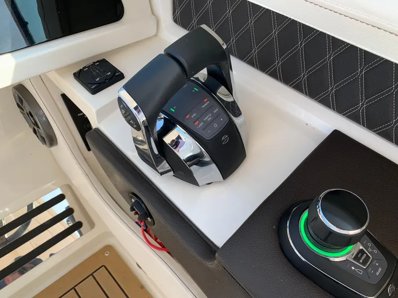 Slide: The Image of 2019 Sea Ray SLX 310 boat controls with modern dashboard and joystick. - 20