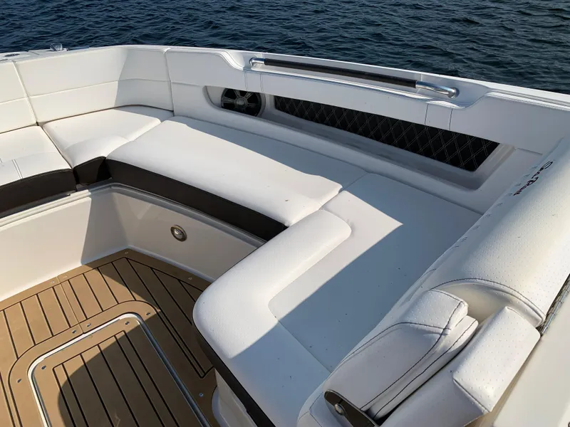 Slide: The Image of 2019 Sea Ray SLX 310 boat with white seating and teak flooring. - 25