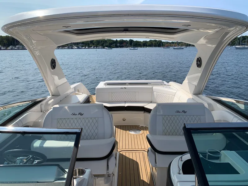Slide: The Image of 2019 Sea Ray SLX 310 boat interior with luxurious seating on a sunny day. - 28