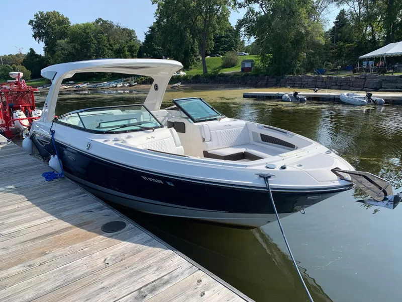 Slide: The Image of 2019 Sea Ray SLX 310 boat docked on a sunny day. - 29