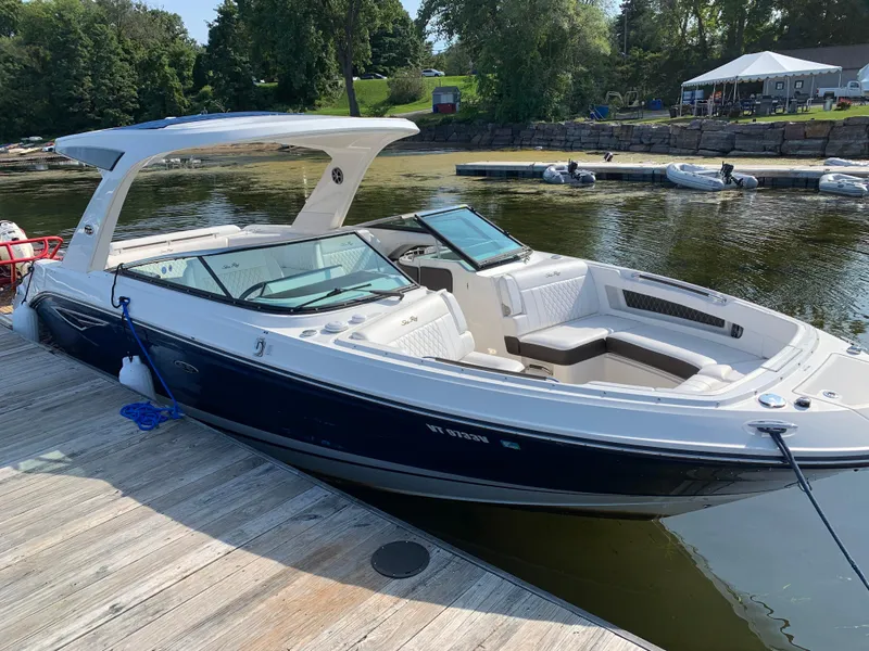 Slide: The Image of 2019 Sea Ray SLX 310 boat docked on a sunny day. - 30