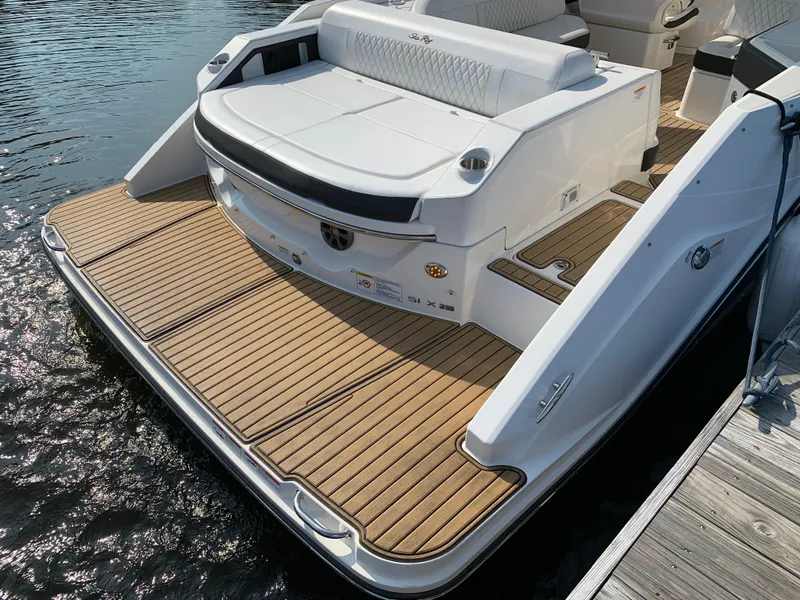 Slide: The Image of 2019 Sea Ray SLX 310 boat with teak swim platform and seating. - 32
