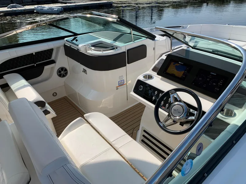 Slide: The Image of 2019 Sea Ray SLX 310 boat interior with modern dashboard and seating. - 34