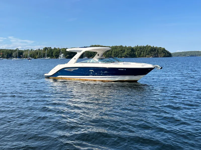 Slide: The Image of 2019 Sea Ray SLX 310 boat on a serene lake. - 36