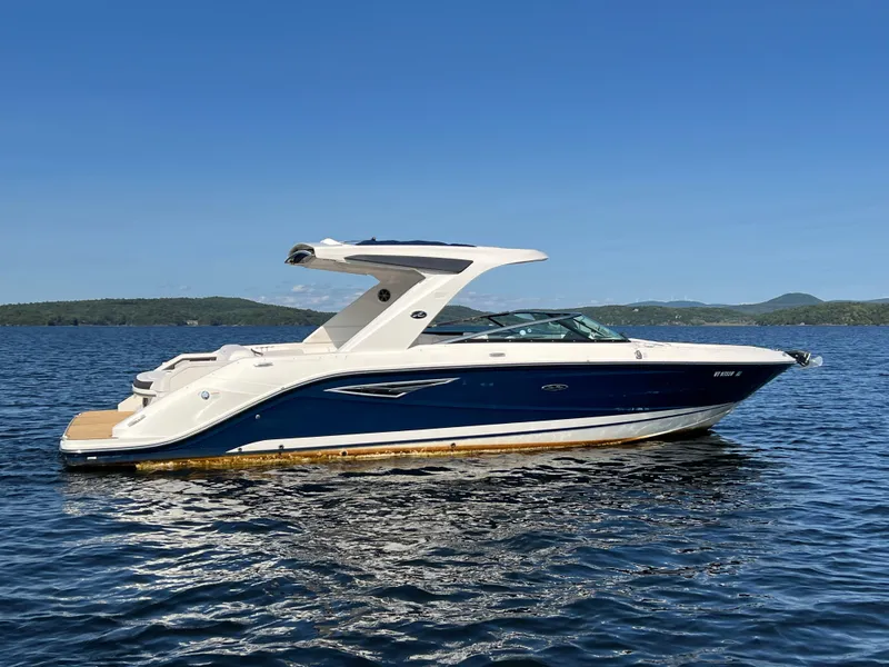 Slide: The Image of 2019 Sea Ray SLX 310 boat on a calm lake. - 38