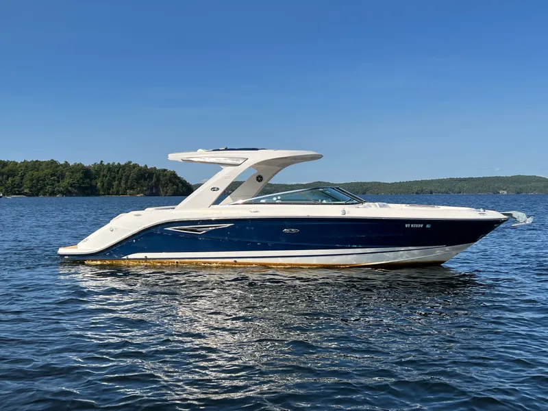 Slide: The Image of 2019 Sea Ray SLX 310 boat on a calm lake. - 4