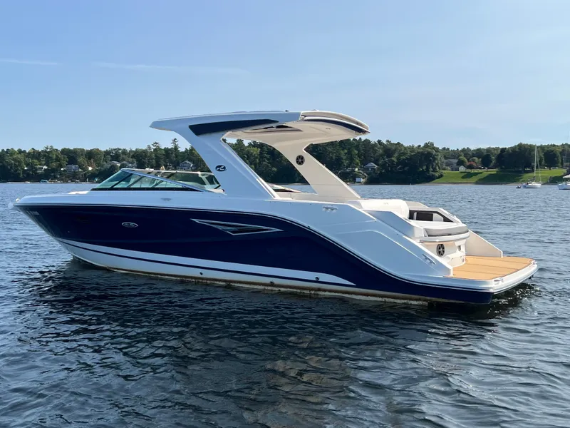 Slide: The Image of 2019 Sea Ray SLX 310 boat on a calm lake. - 48