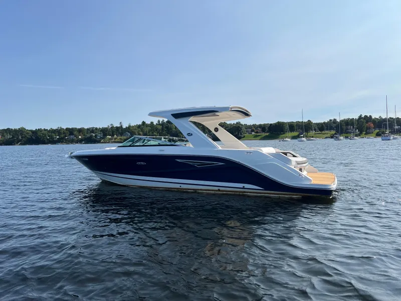 Slide: The Image of 2019 Sea Ray SLX 310 boat on a calm lake. - 49
