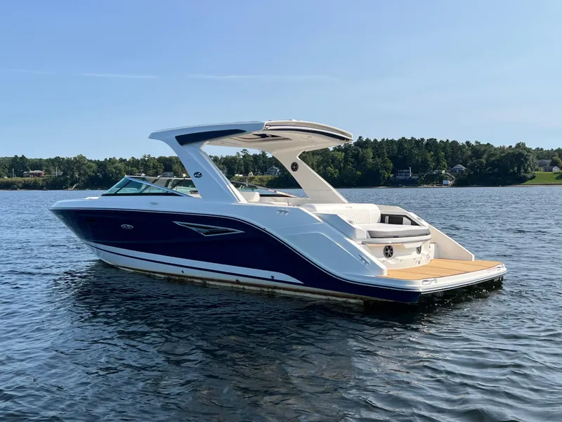 Slide: The Image of 2019 Sea Ray SLX 310 boat on a calm lake. - 5