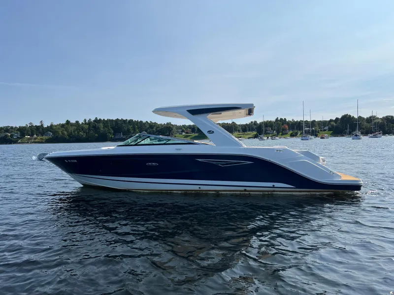 Slide: The Image of 2019 Sea Ray SLX 310 boat on calm water, scenic background. - 6