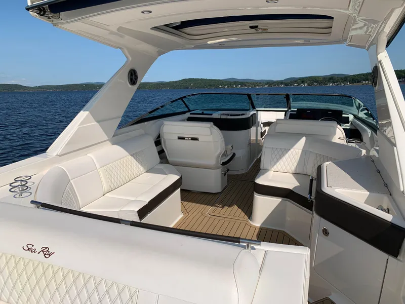 Slide: The Image of 2019 Sea Ray SLX 310 boat interior with white seating, open water view. - 7