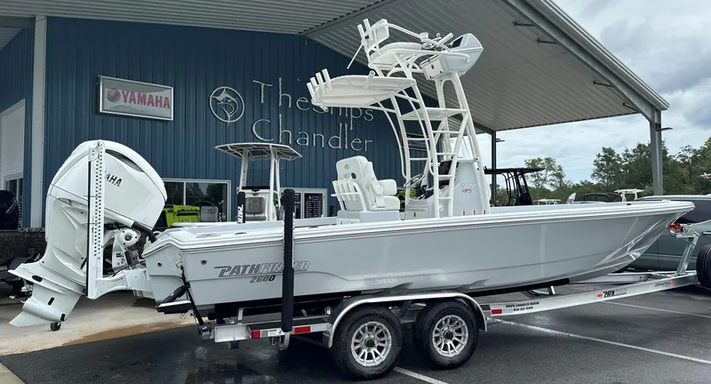 Slide: The Image of 2025 Pathfinder 2600 HPS boat on trailer outside dealership. - 11