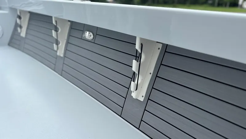 Slide: The Image of 2025 Pathfinder 2600 HPS boat interior with sleek, modern paneling and secure rod holders. - 17