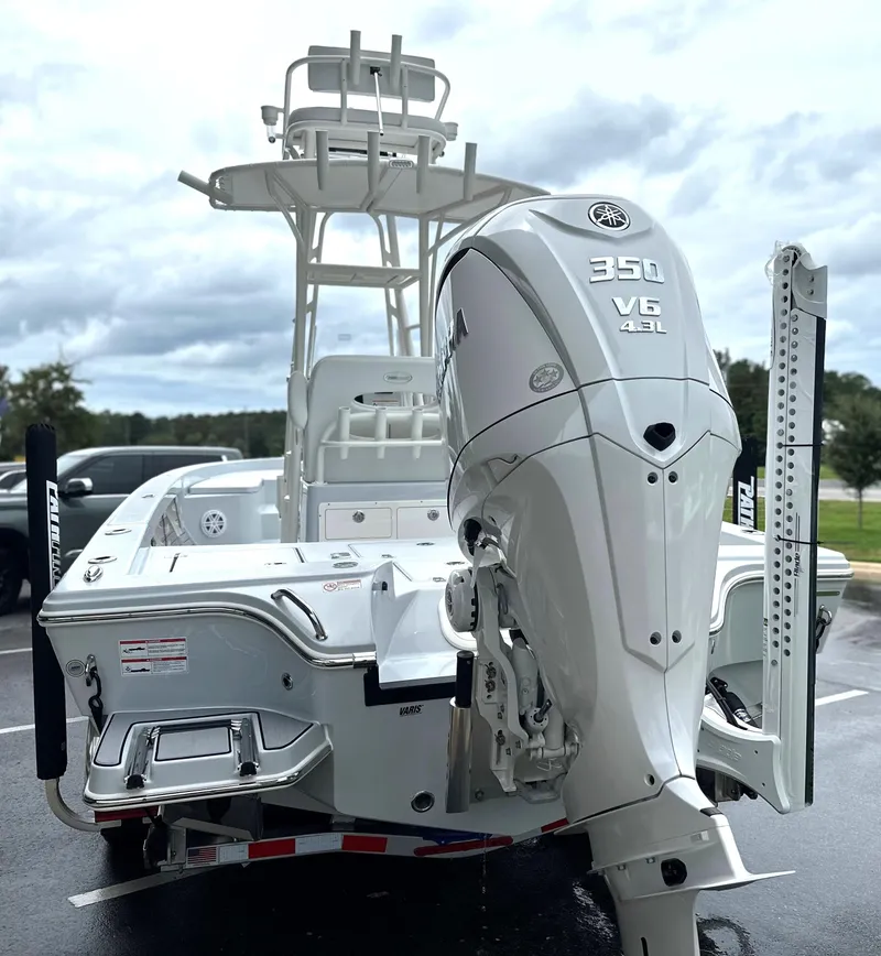 Slide: The Image of 2025 Pathfinder 2600 HPS boat with powerful 350 V6 engine, parked outdoors. - 2