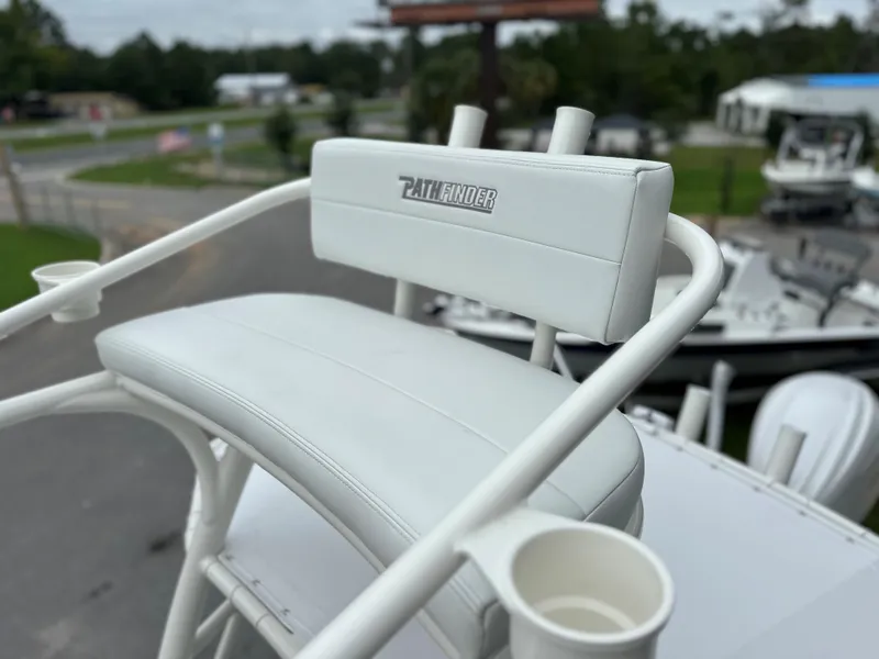 Slide: The Image of 2025 Pathfinder 2600 HPS boat seat with cup holders, outdoor setting. - 24