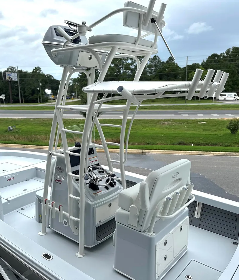 Slide: The Image of 2025 Pathfinder 2600 HPS boat with elevated helm and seating, parked near a road. - 8
