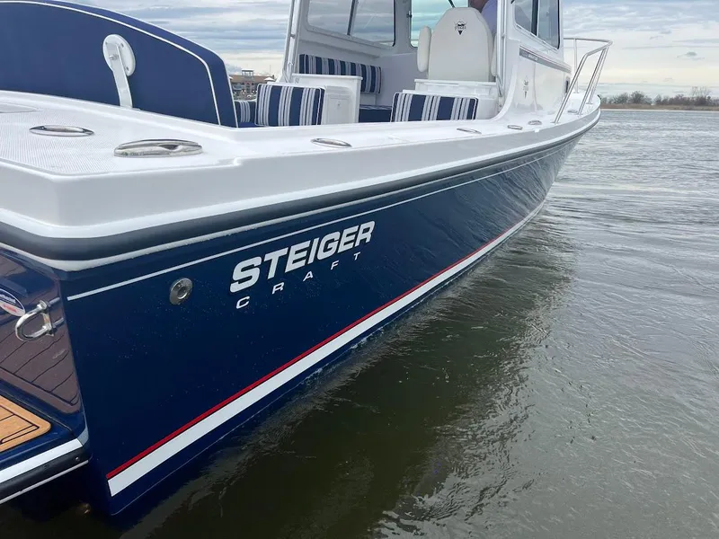 Slide: The Image of 2025 Steiger Craft 255 Annapolis boat on water, showcasing sleek design and craftsmanship. - 12