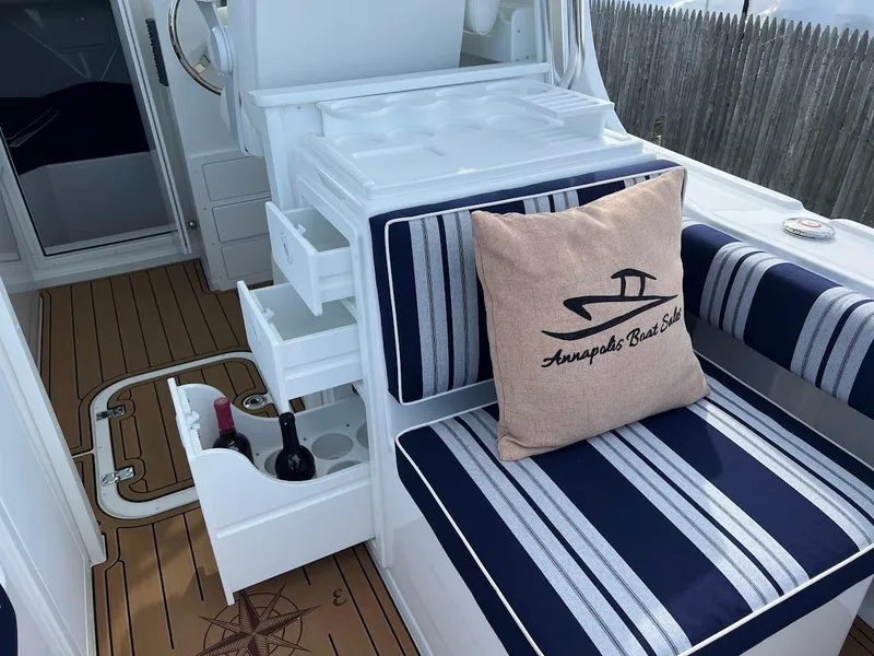 Slide: The Image of Steiger Craft 255 Annapolis 2025 boat interior with striped seating and storage compartments. - 22