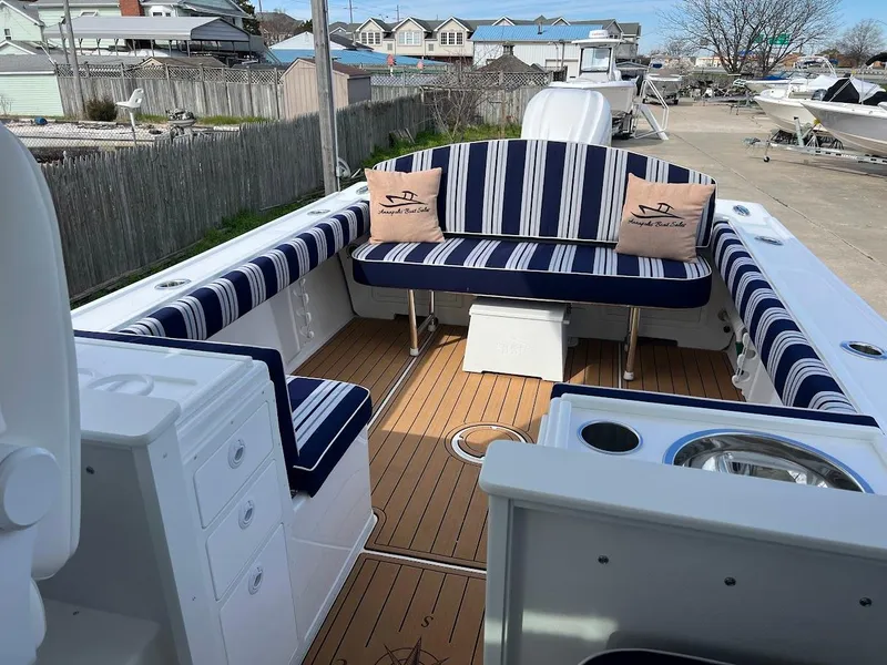 Slide: The Image of 2025 Steiger Craft 255 Annapolis boat with striped seating and wooden deck. - 28