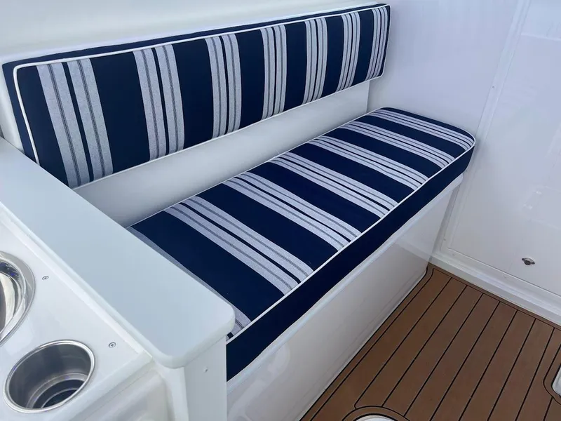 Slide: The Image of Striped seating on 2025 Steiger Craft 255 Annapolis boat with wood-style flooring. - 30