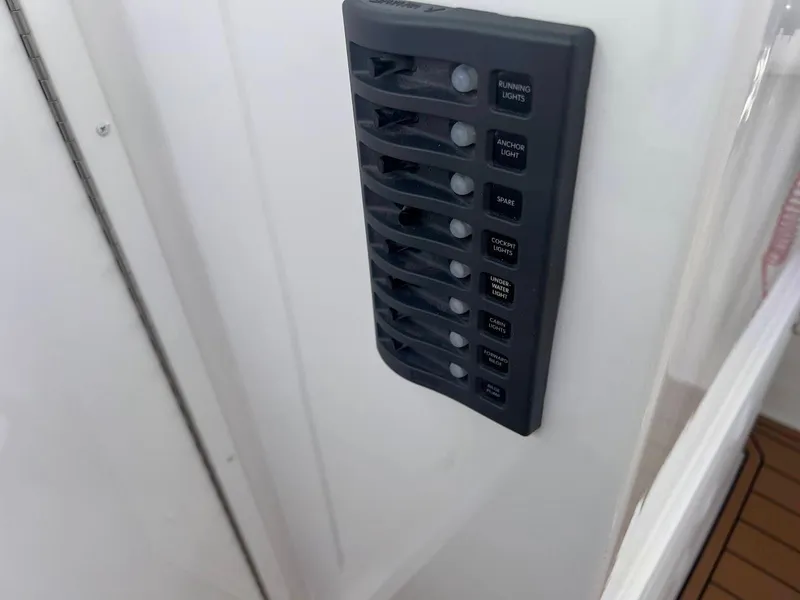 Slide: The Image of Control panel on 2025 Steiger Craft 255 Annapolis boat, featuring multiple switches. - 37