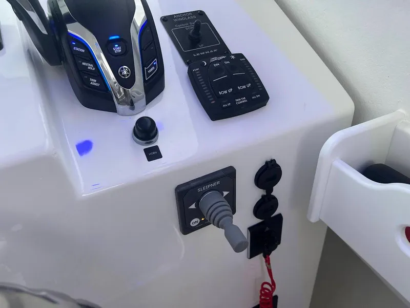 Slide: The Image of Control panel of 2025 Steiger Craft 255 Annapolis boat with throttle and switches. - 38