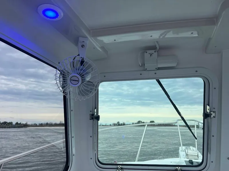 Slide: The Image of Interior view of 2025 Steiger Craft 255 Annapolis boat with window and fan. - 39