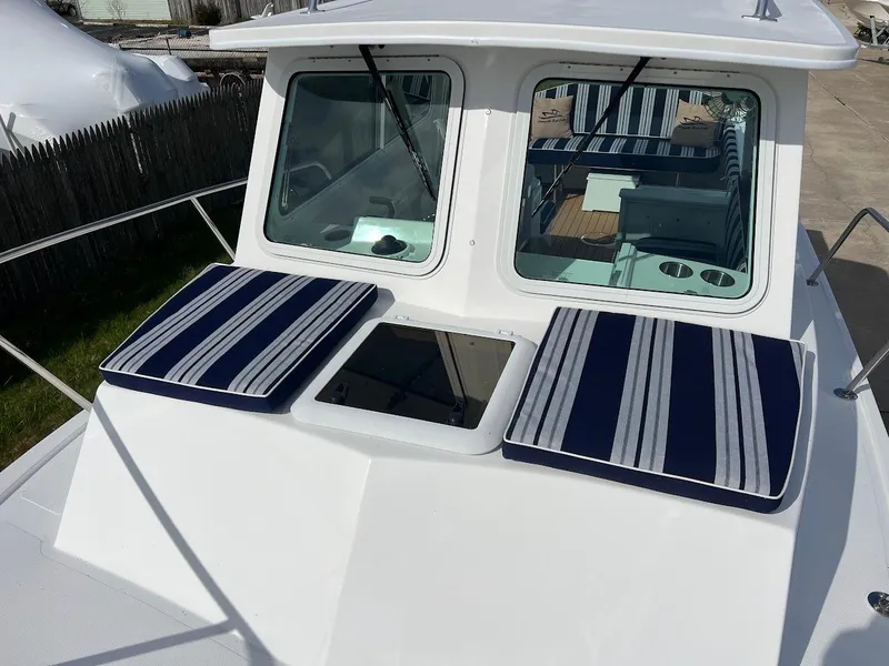 Slide: The Image of 2025 Steiger Craft 255 Annapolis boat with striped cushions on deck. - 40