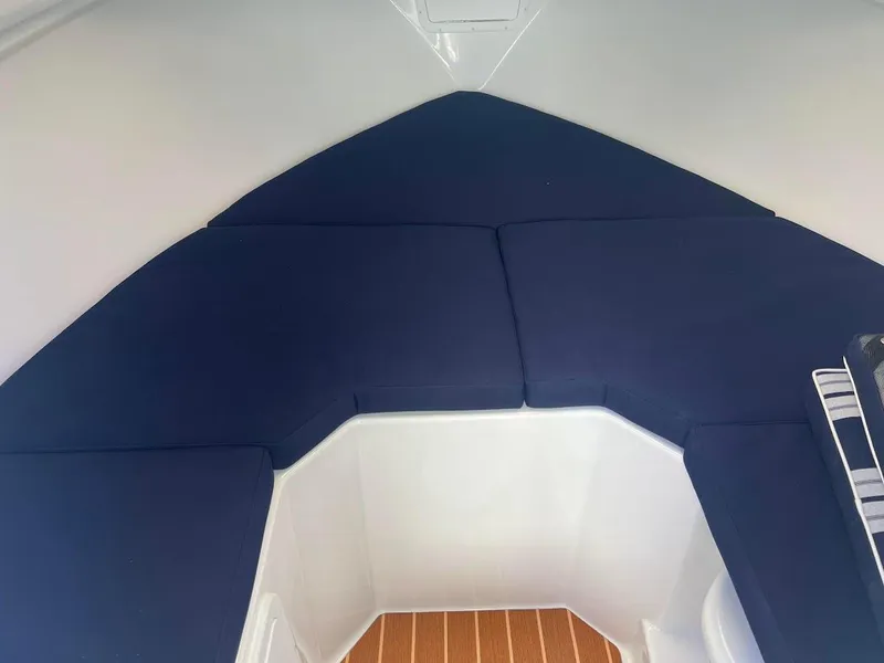 Slide: The Image of Interior cabin of 2025 Steiger Craft 255 Annapolis with blue cushions. - 42