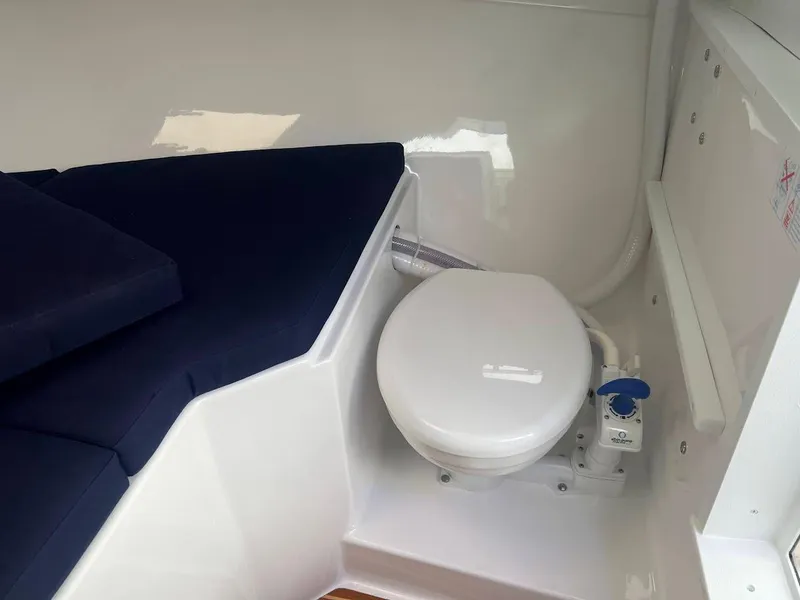 Slide: The Image of 2025 Steiger Craft 255 Annapolis boat interior with toilet and seating area. - 43