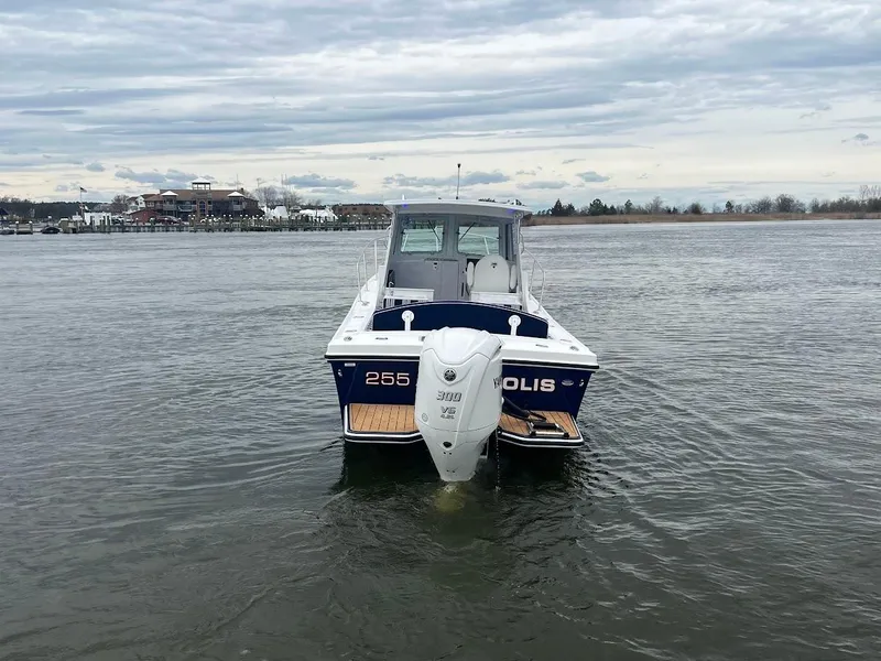 Slide: The Image of 2025 Steiger Craft 255 Annapolis boat on water, cloudy sky background. - 9