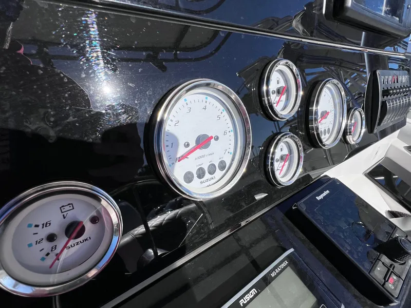 Slide: The Image of Dashboard of Dakota 32 cc 2023 Suzuki Motors, featuring multiple gauges and controls. - 10